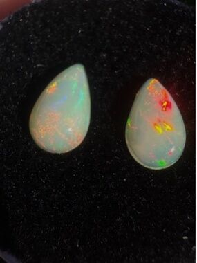 Genuine flashy pair of opals pear cut in gem jar